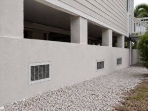 Installed flood vents below an elevated home for an Elevation Certificate review in Pembroke Pines, Florida.