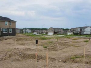 Residential development site with survey stakes and new homes in Pembroke Pines, FL, supporting land survey planning for attainable housing.
